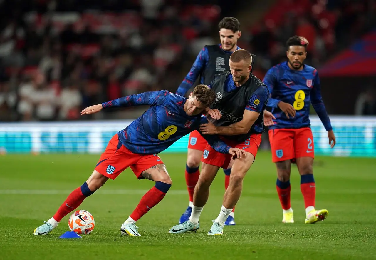 Eric Dier (centre) and John Stones (left) warm up