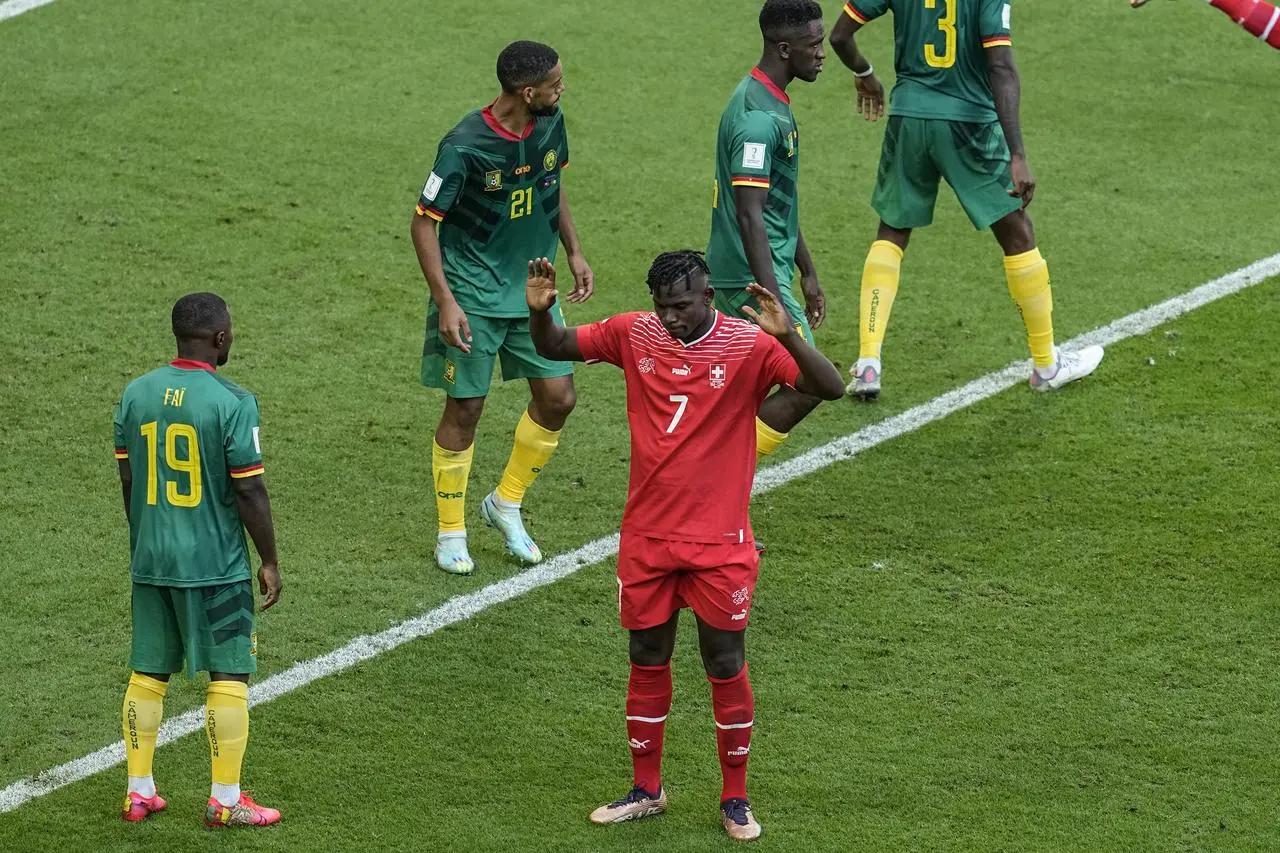 Switzerland’s Breel Embolo holds his hands up after scoring