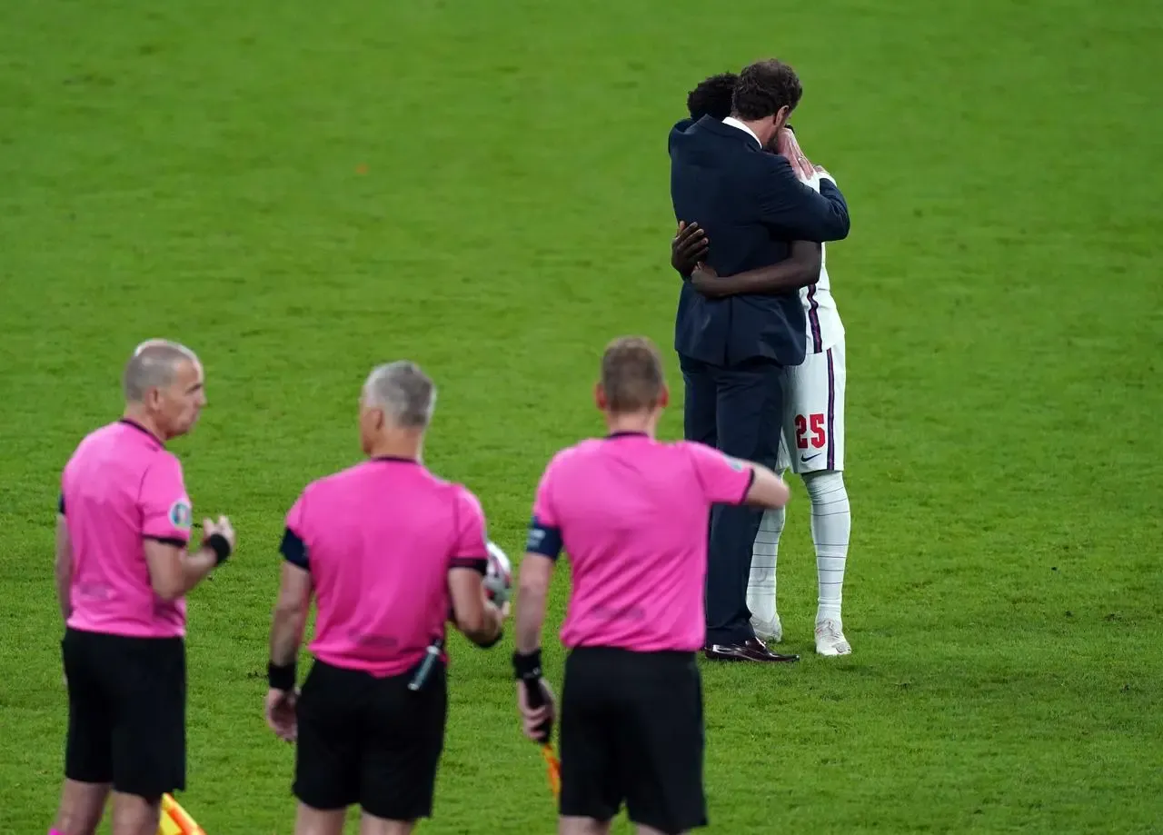 England manager Gareth Southgate consoles Bukayo Saka after the penalty shoot out defeat to Italy.