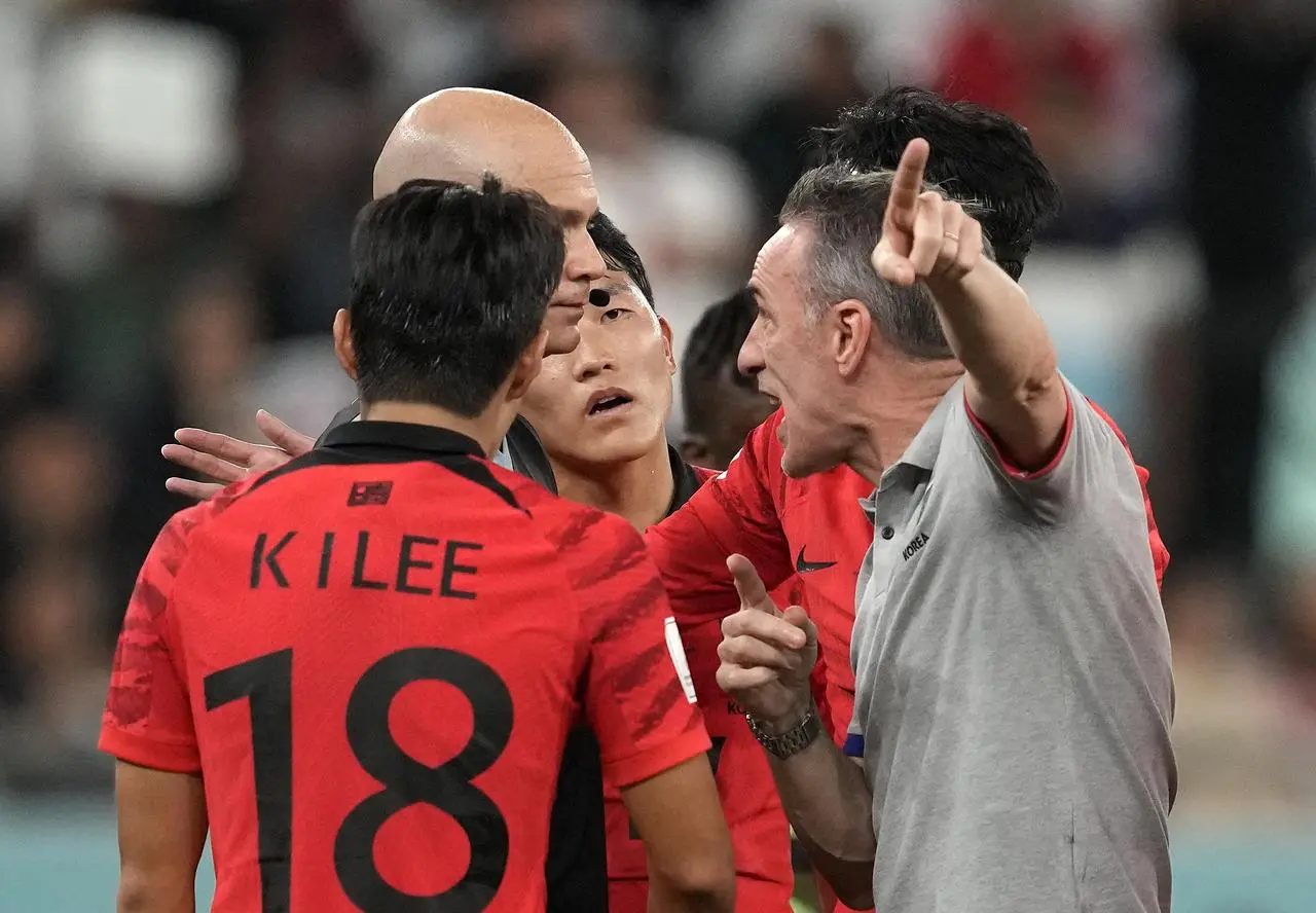 Referee Anthony Taylor is confronted by Paulo Bento 