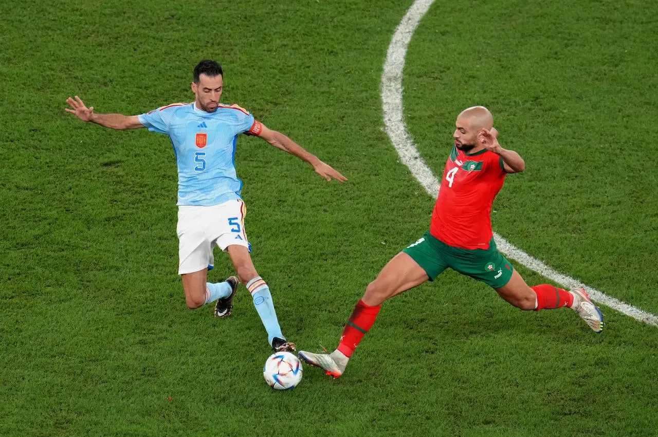 Morocco’s Sofyan Amrabat tackles Spain's Sergio Busquets