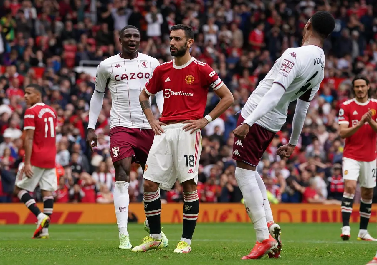 Bruno Fernandes reacts to his penalty miss last season as Aston Villa players celebrate