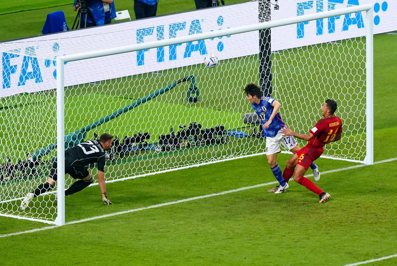 Japan’s Ao Tanaka scores against Spain