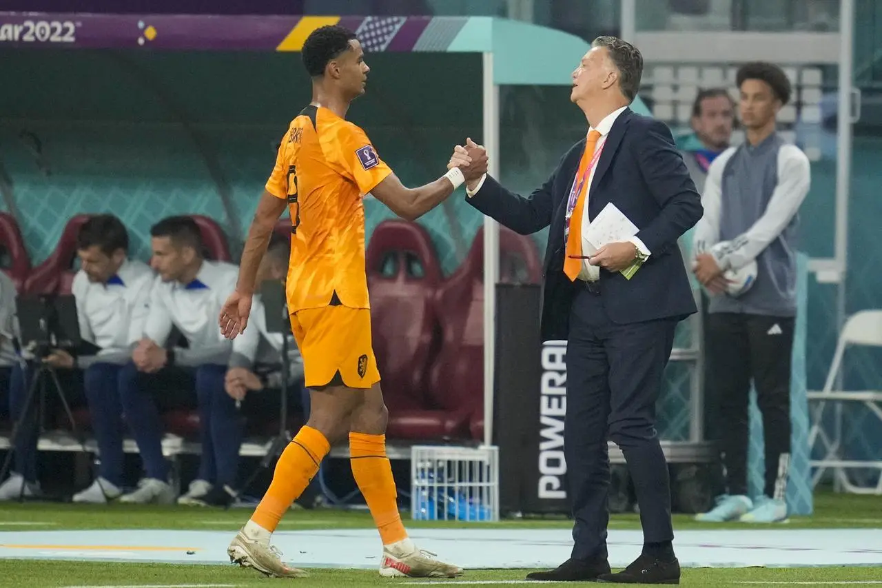 Cody Gakpo, left, is congratulated by Netherlands coach Louis van Gaal