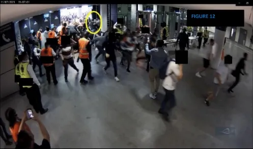 A man holding a young child is supported by a steward after he is swept in through an emergency fire door which has been forced open ahead of the Euro 2020 final at Wembley 