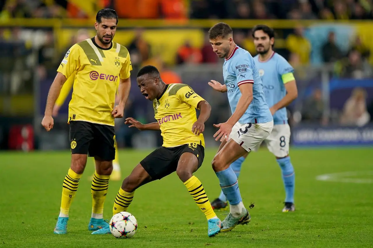 Borussia Dortmund's Youssoufa Moukoko (centre) and Manchester City's Ruben Dias in action during the UEFA Champions League group G match at Signal Iduna Park in Dortmund, Germany