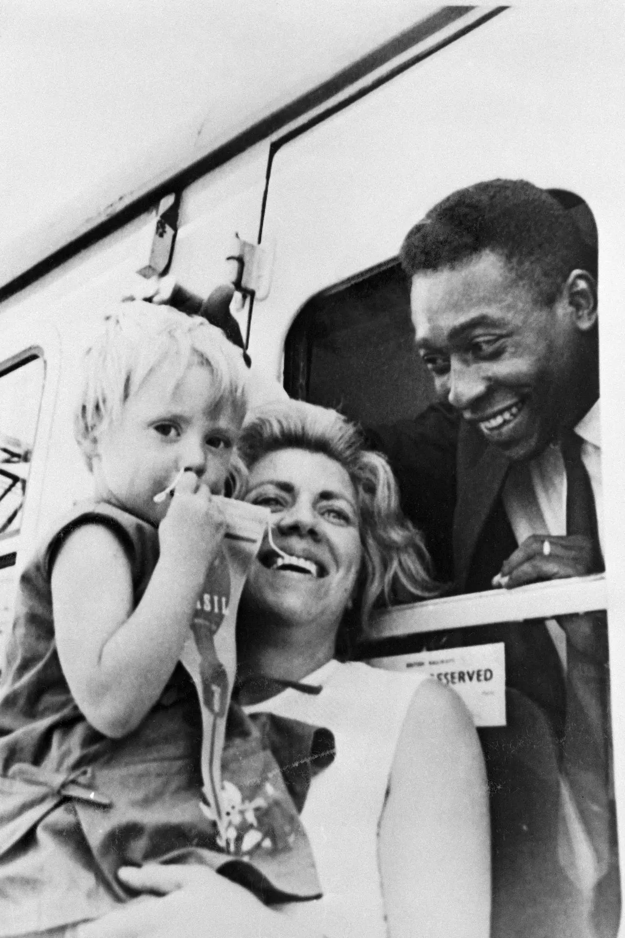 Virginia Ferrari, left, is held up to say goodbye to Pele in Manchester 