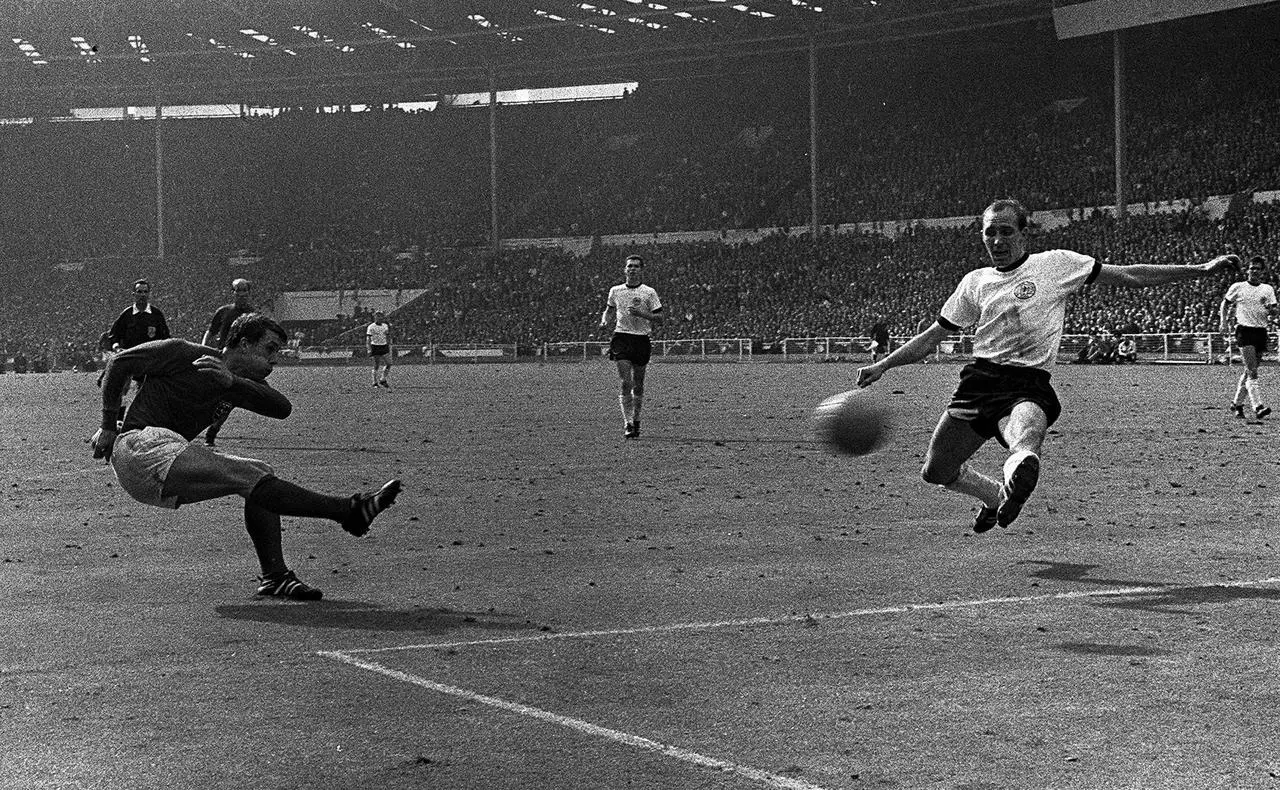 Sir Geoff Hurst, left, scores his second of three goals in the 1966 World Cup final