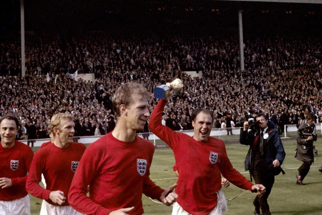 Ray Wilson, right, celebrates with the World Cup trophy