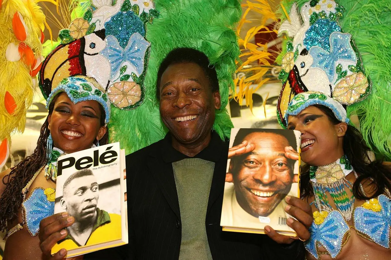 Pele, centre, promotes his autobiography with Brazilian dancers at Easons Bookstore, Dublin in May 2006