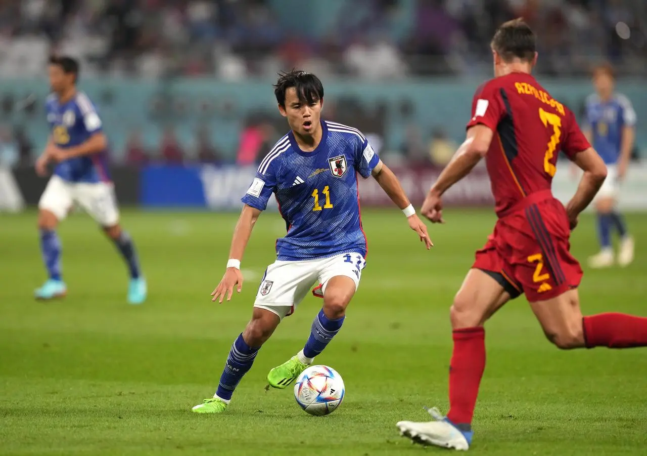 Japan’s Takefusa Kubo (centre) and Spain’s Cesar Azpilicueta battle for the ball