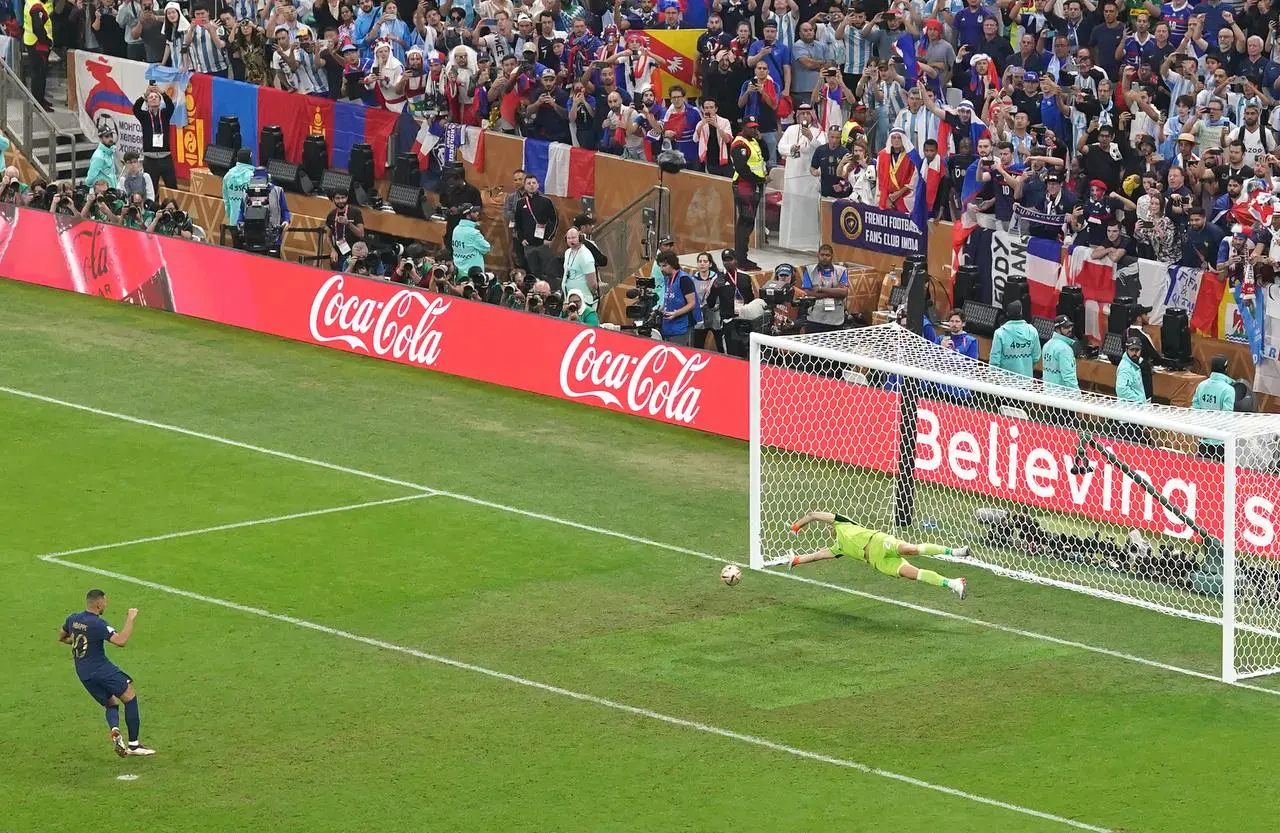 Mbappe scores his first penalty in Sunday's clash with Argentina (Adam Davy/PA). 