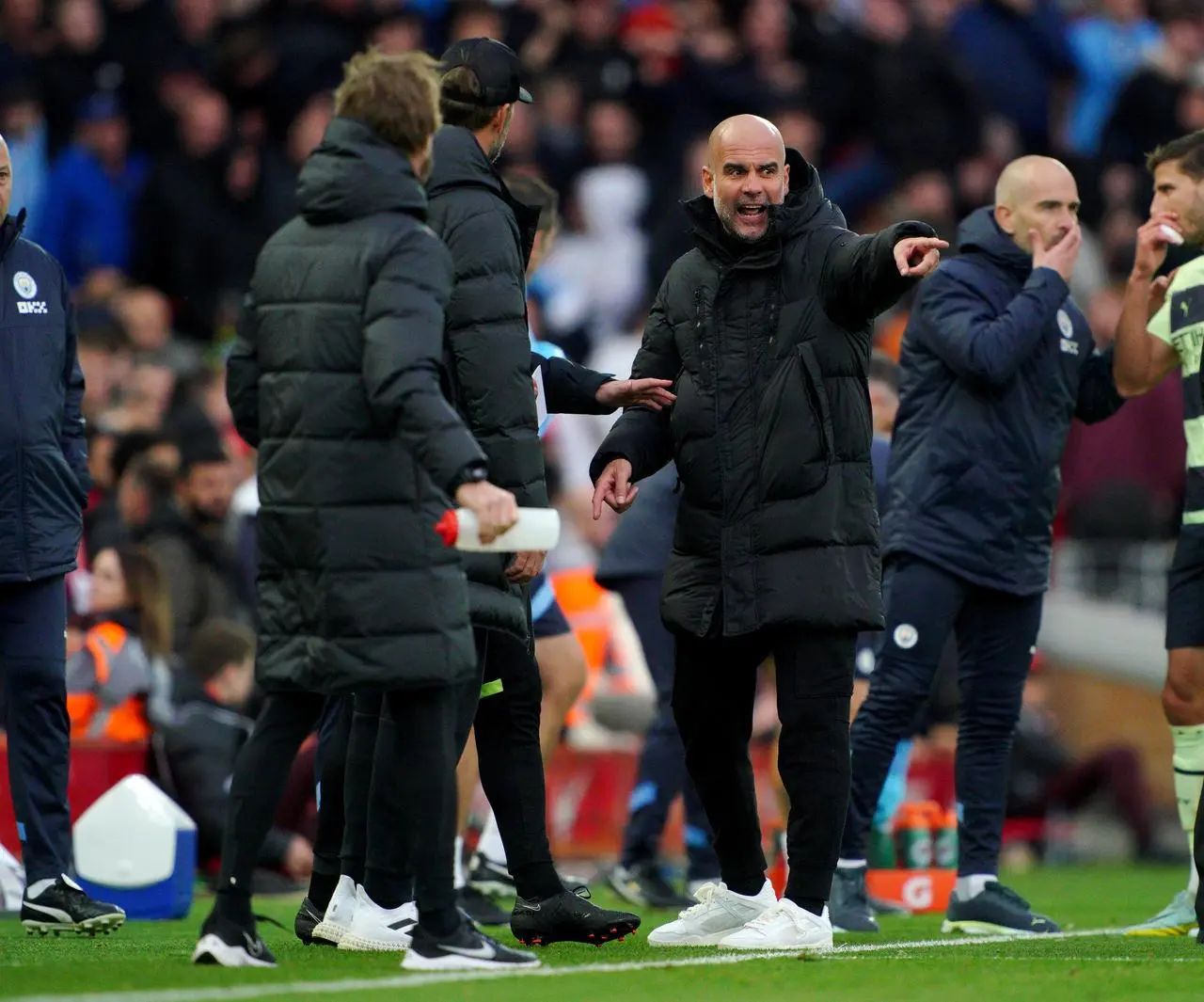 Pep Guardiola (centre) speaks with Jurgen Klopp