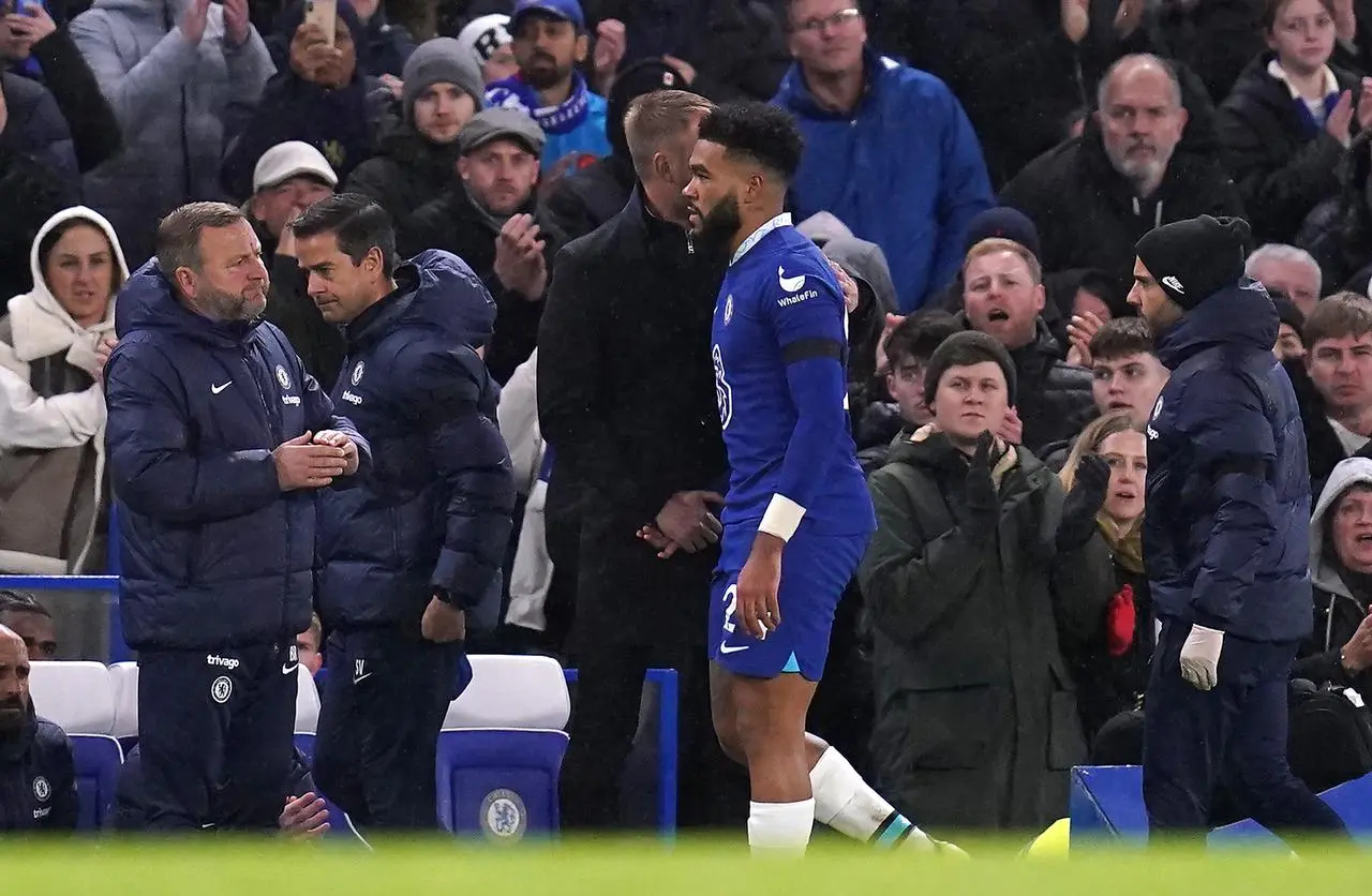 Chelsea’s Reece James shake hands with manager Graham Potter after walking off the field injured