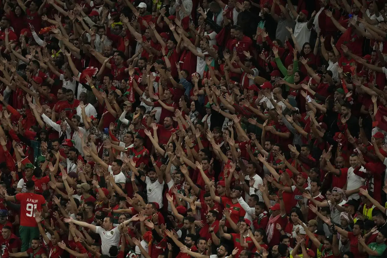 Moroccan fans cheer their team