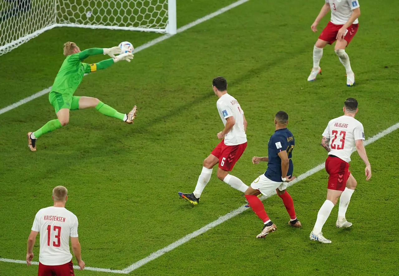 Kylian Mbappe, centre, scores France’s first goal against Denmark