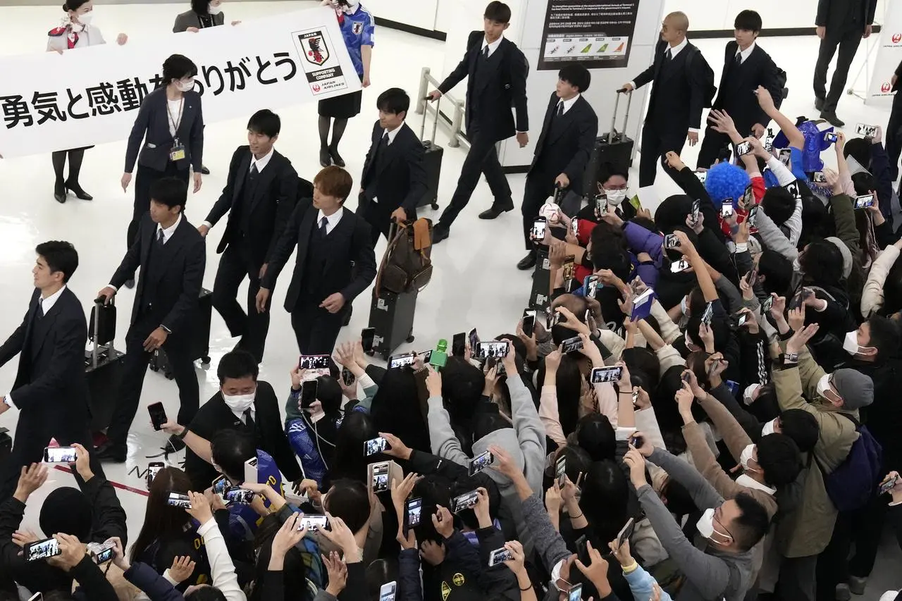 Japan may have lost in the last 16 but they were awarded a hero's welcome on their return to Tokyo on Wednesday 