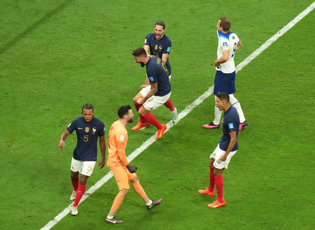 England’s Harry Kane reacts after missing a penalty while France players celebrate