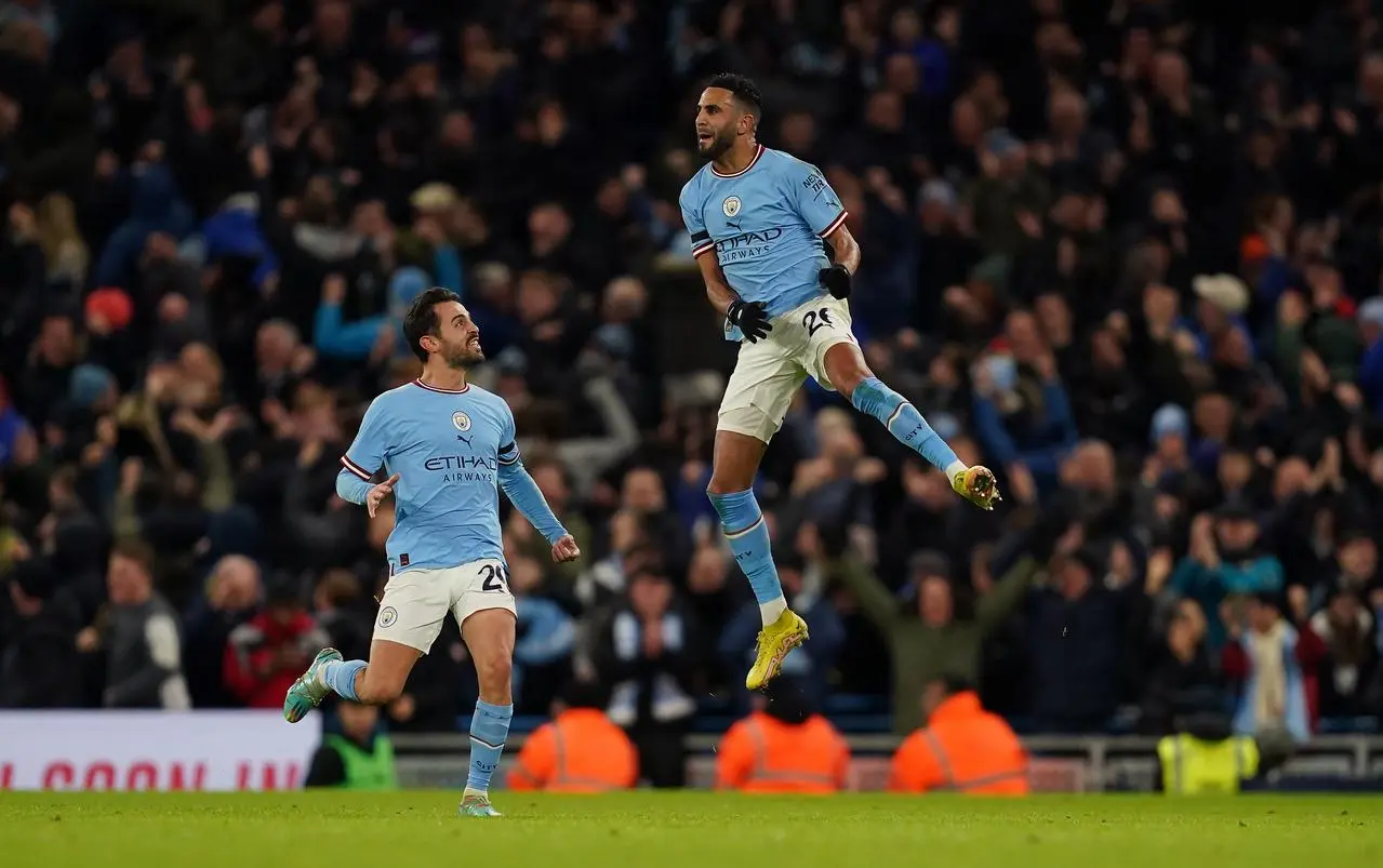 Riyad Mahrez (right) celebrates one of his two goals against Chelsea with Bernardo Silva