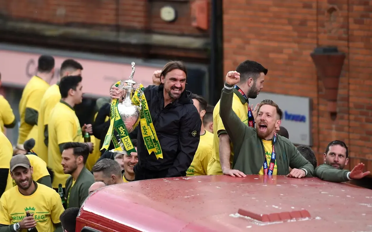 Norwich head coach Daniel Farke (centre) with the Championship trophy during a promotion parade