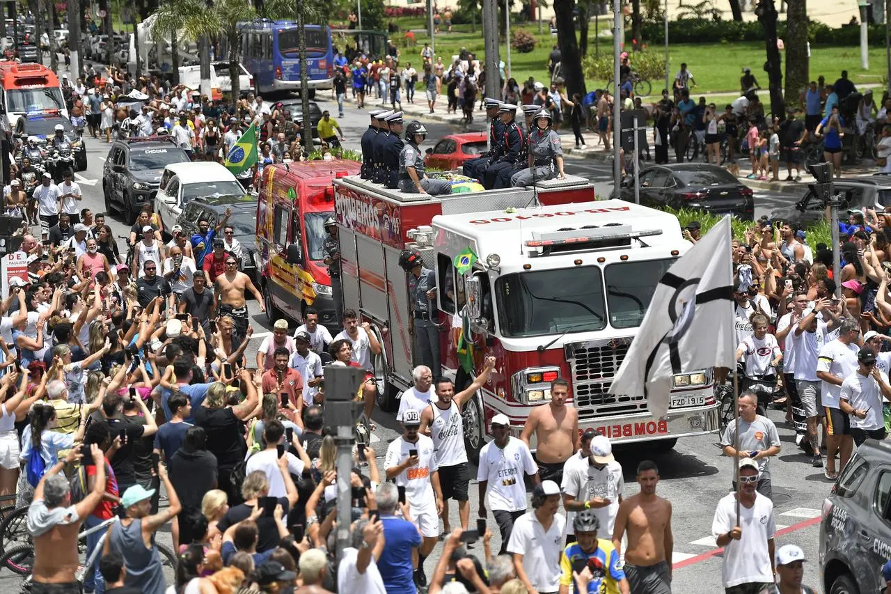 Pele's coffin was driven through the streets of Santos as thousands gathered to pay their respects