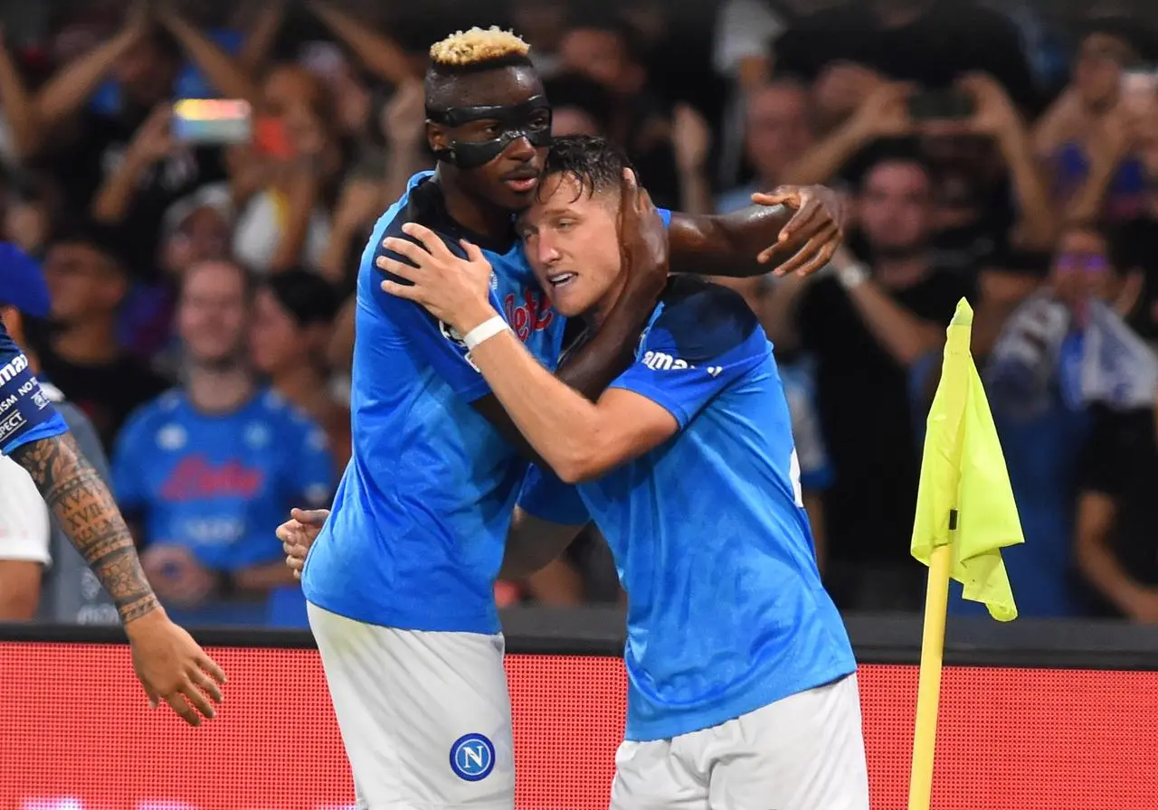 Napoli’s Piotr Zielinski celebrates with Victor Osimhen