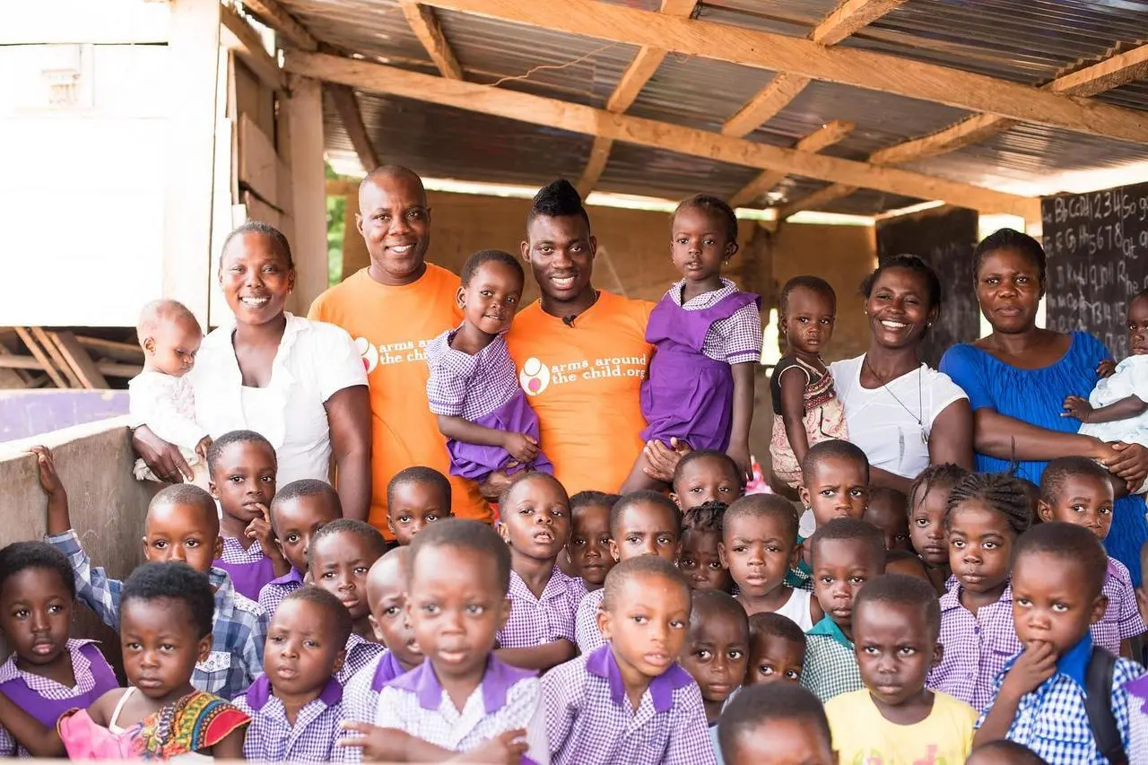 Arms Around The Child ambassador Christian Atsu with children in Ghana (Arms Around the Child/PA handout).