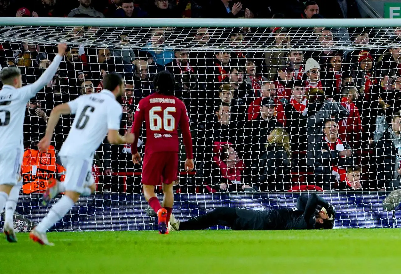 Liverpool goalkeeper Alisson Becker, right, reacts after Real Madrid’s fourth goal