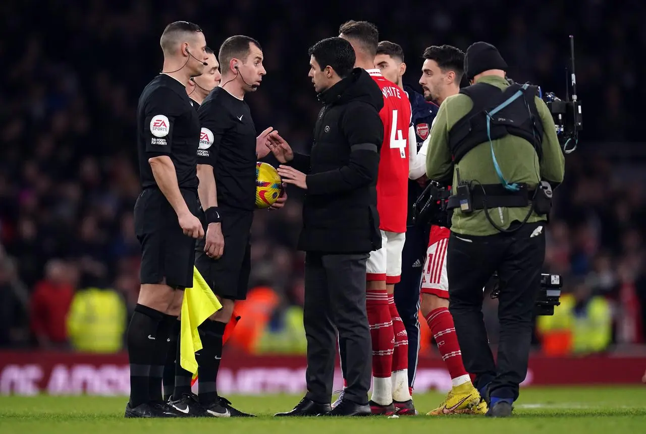 Mikel Arteta, centre, speaks to the match officials after Arsenal's draw with Brentford