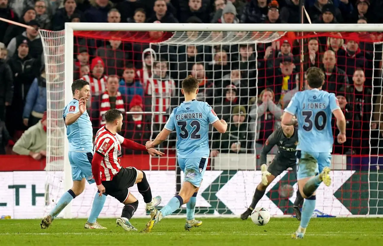 Billy Sharp, second left, scores Sheffield United’s second goal