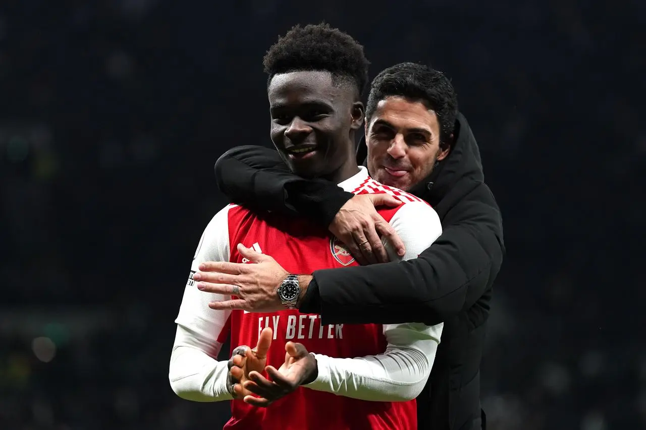 Bukayo Saka, left, celebrates with Arsenal manager Mikel Arteta after victory over Tottenham