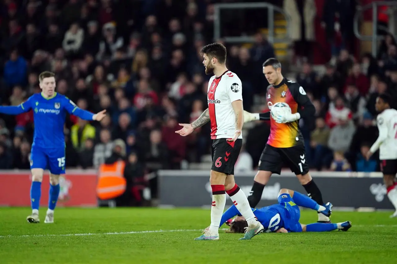 Danilo Orsi lies on the ground as Southampton’s Duje Caleta-Car reacts after conceding a penalty