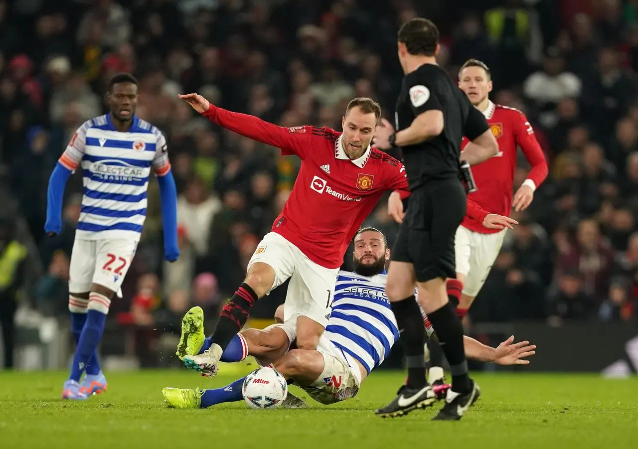 Christian Eriksen (left) and Andy Carroll battle for the ball