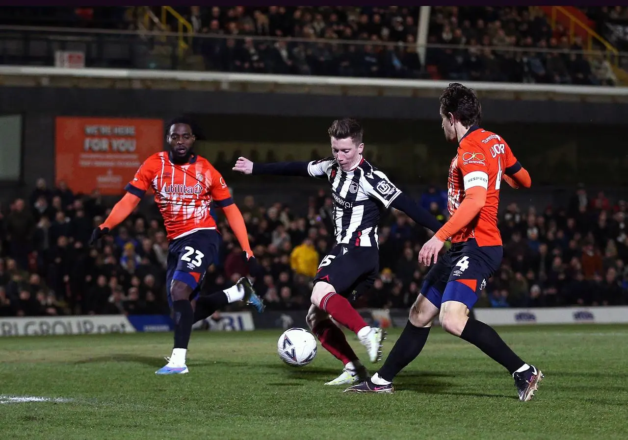 Harry Clifton, centre, scores in Grimsby's replay win over Luton