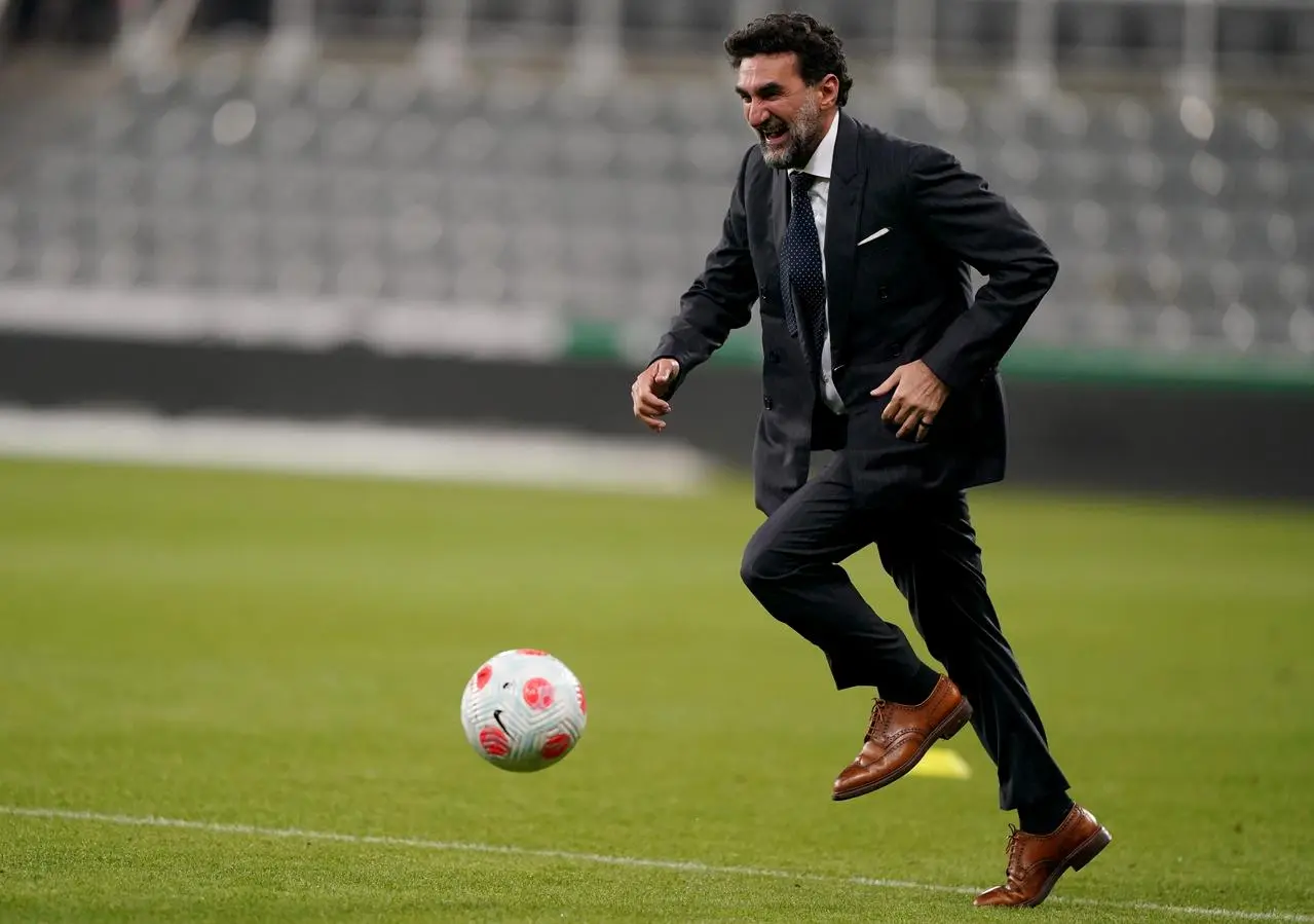 Newcastle United Chairman Yasir Al-Rumayyan plays football on the pitch