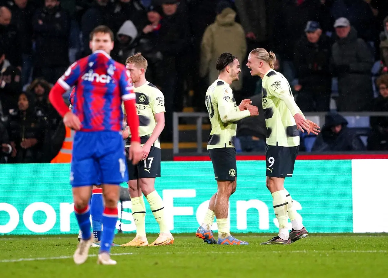 Manchester City’s Erling Haaland celebrates with Jack Grealish