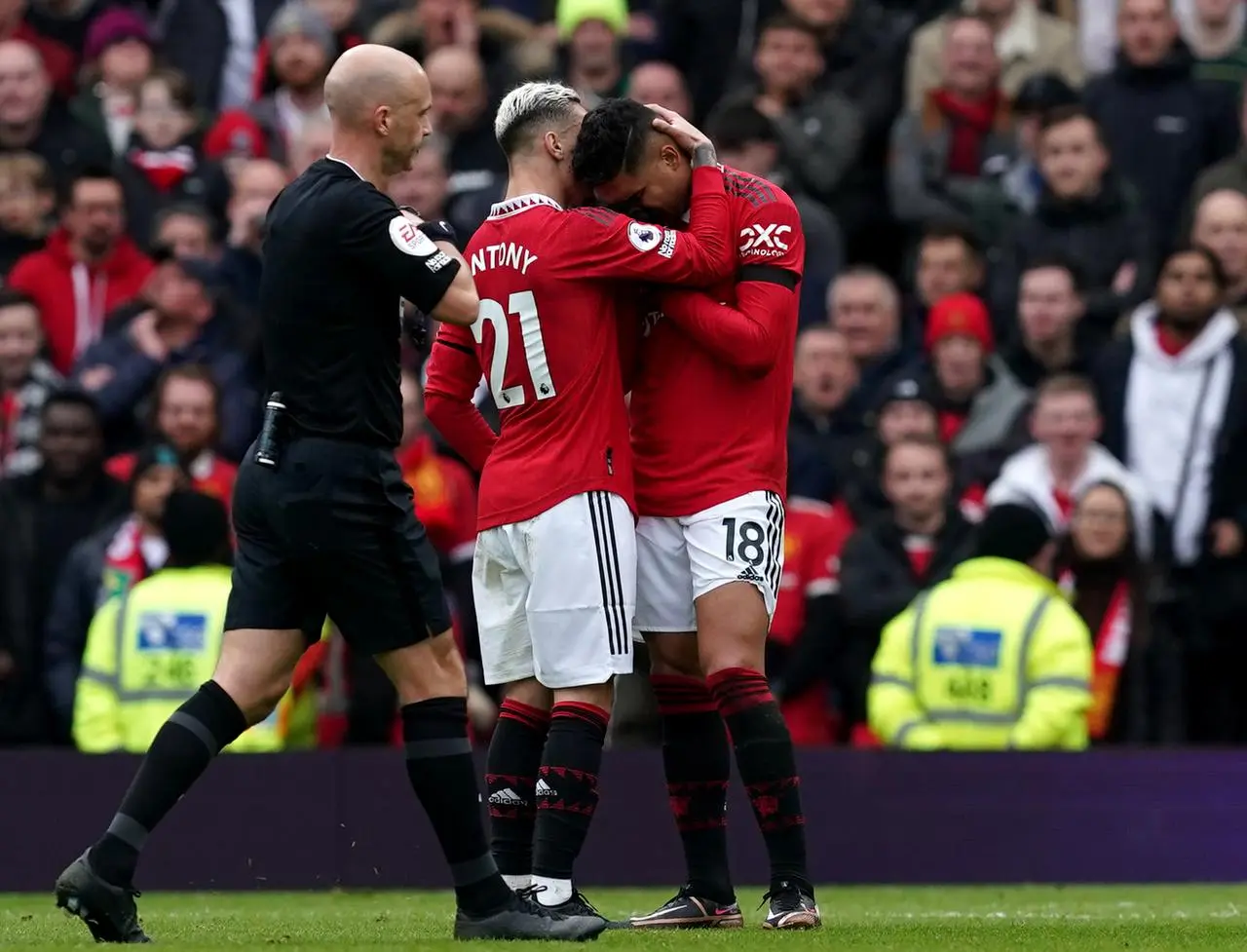 Casemiro is consoled by Antony after being shown a red card 