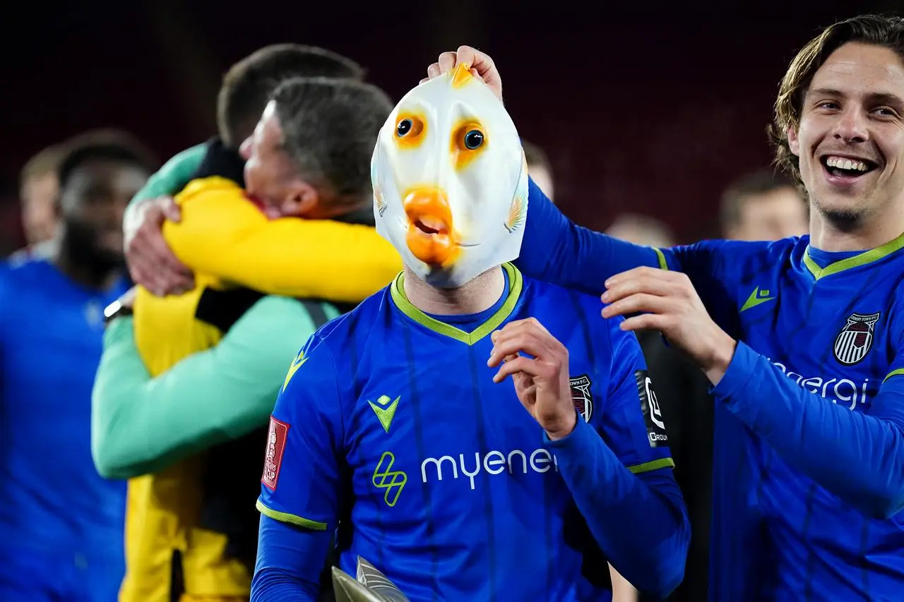 Anthony Glennon celebrates whilst wearing a fish mask