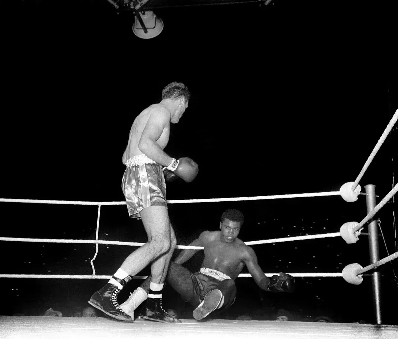 Henry Cooper knocks down Cassius Clay during the fourth round of their fight at Wembley