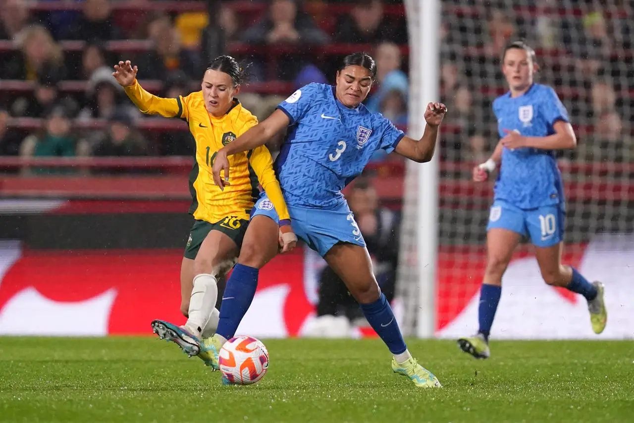 Jess Carter (right) battles for the ball with Australia's Hayley Raso (John Walton/PA)