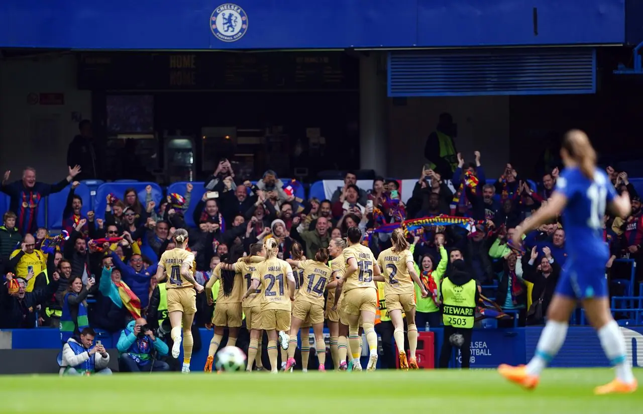 Caroline Hansen celebrates with team-mates after scoring the winner at Chelsea