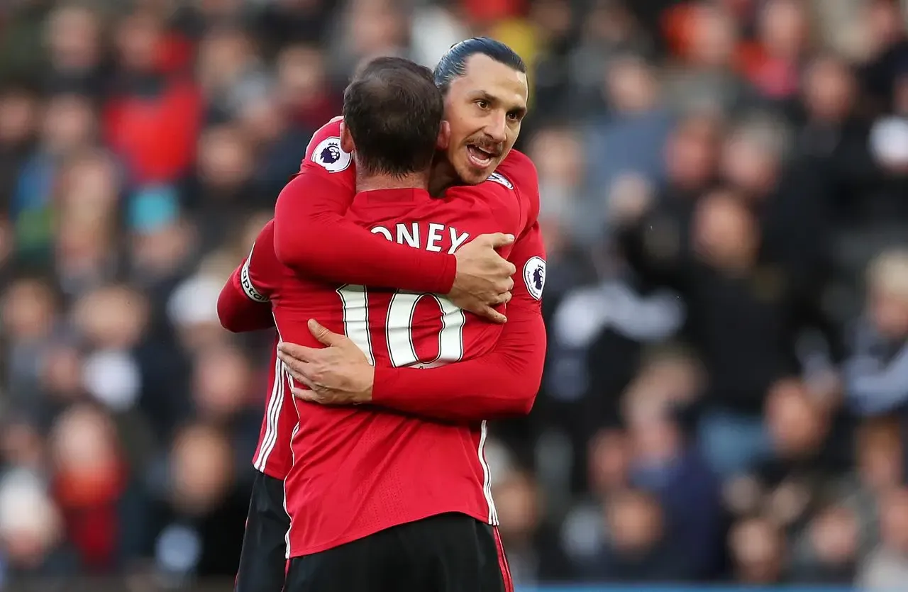 Wayne Rooney is thanked by Zlatan Ibrahimovic, right, after delivering his 100th Premier League assist