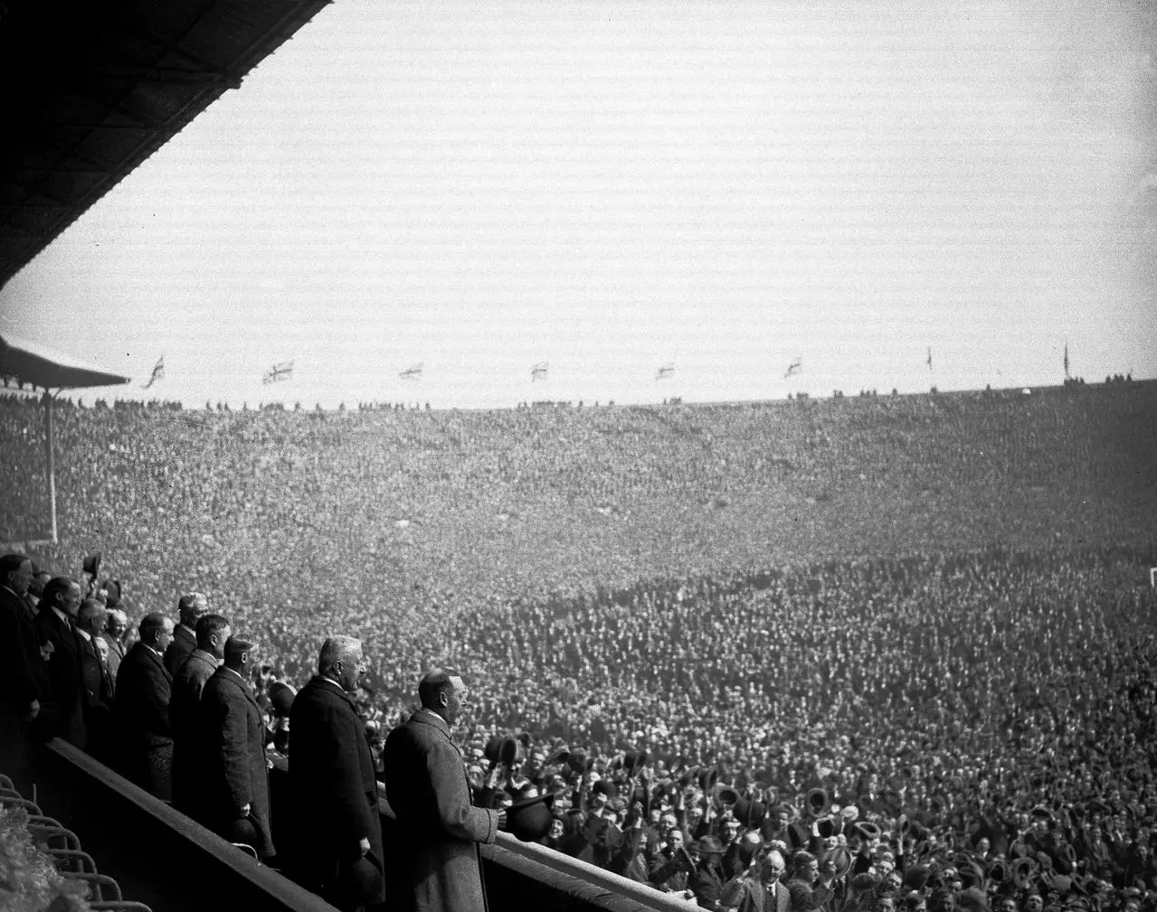 King George V, on the right of the dignitaries section, looks out at the vast crowds in attendance at the 1923 FA Cup final