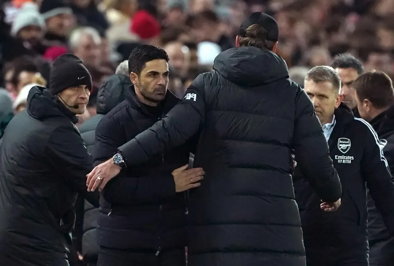 Arsenal boss Mikel Arteta, left, and Liverpool manager Jurgen Klopp shake hands