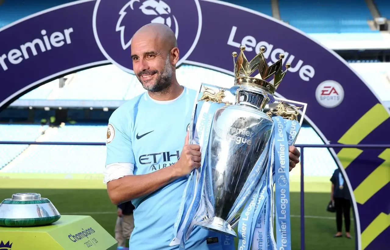 Pep Guardiola with the Premier League trophy