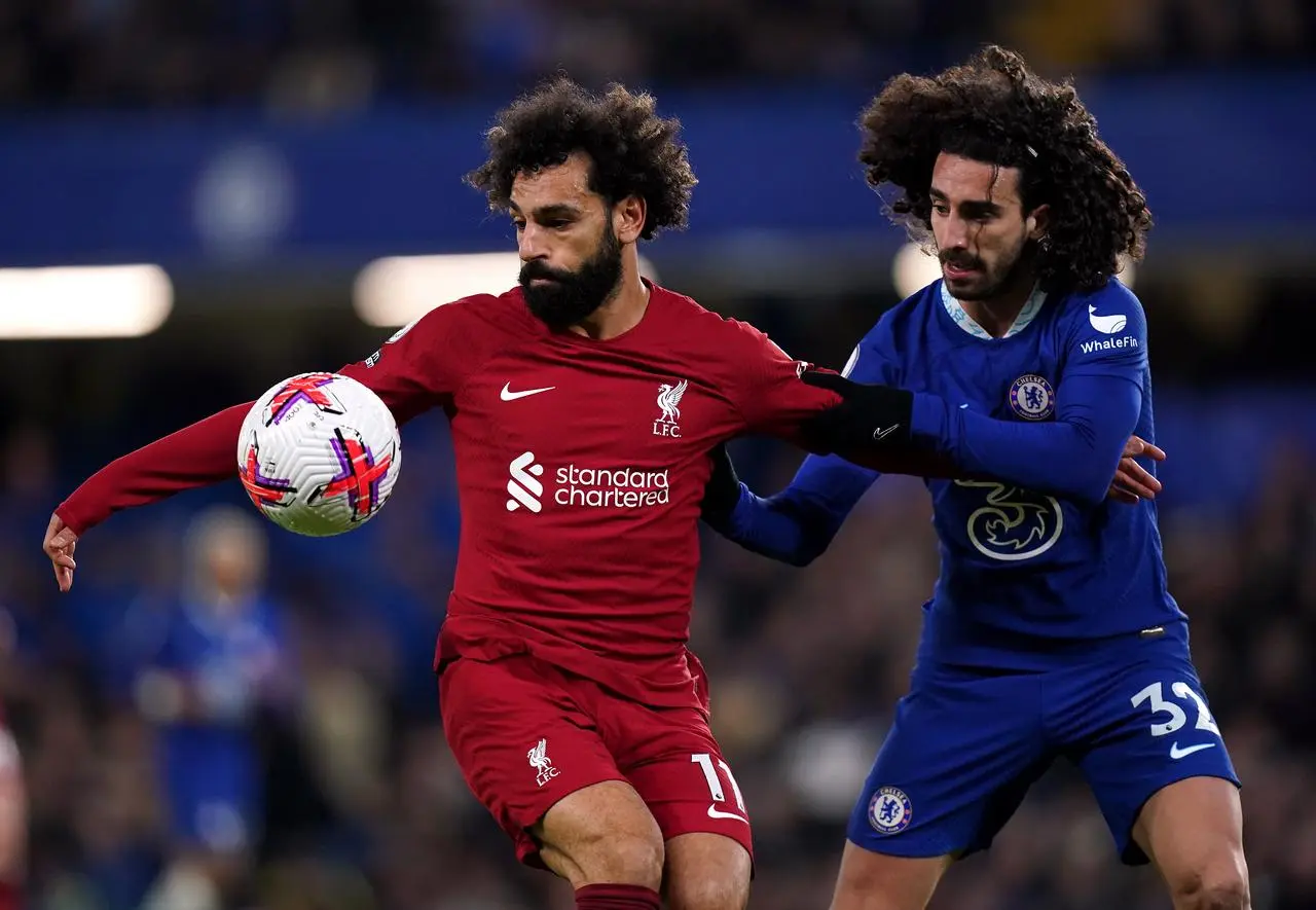 Liverpool substitute Mohamed Salah, left, shields the ball from Chelsea's Marc Cucurella