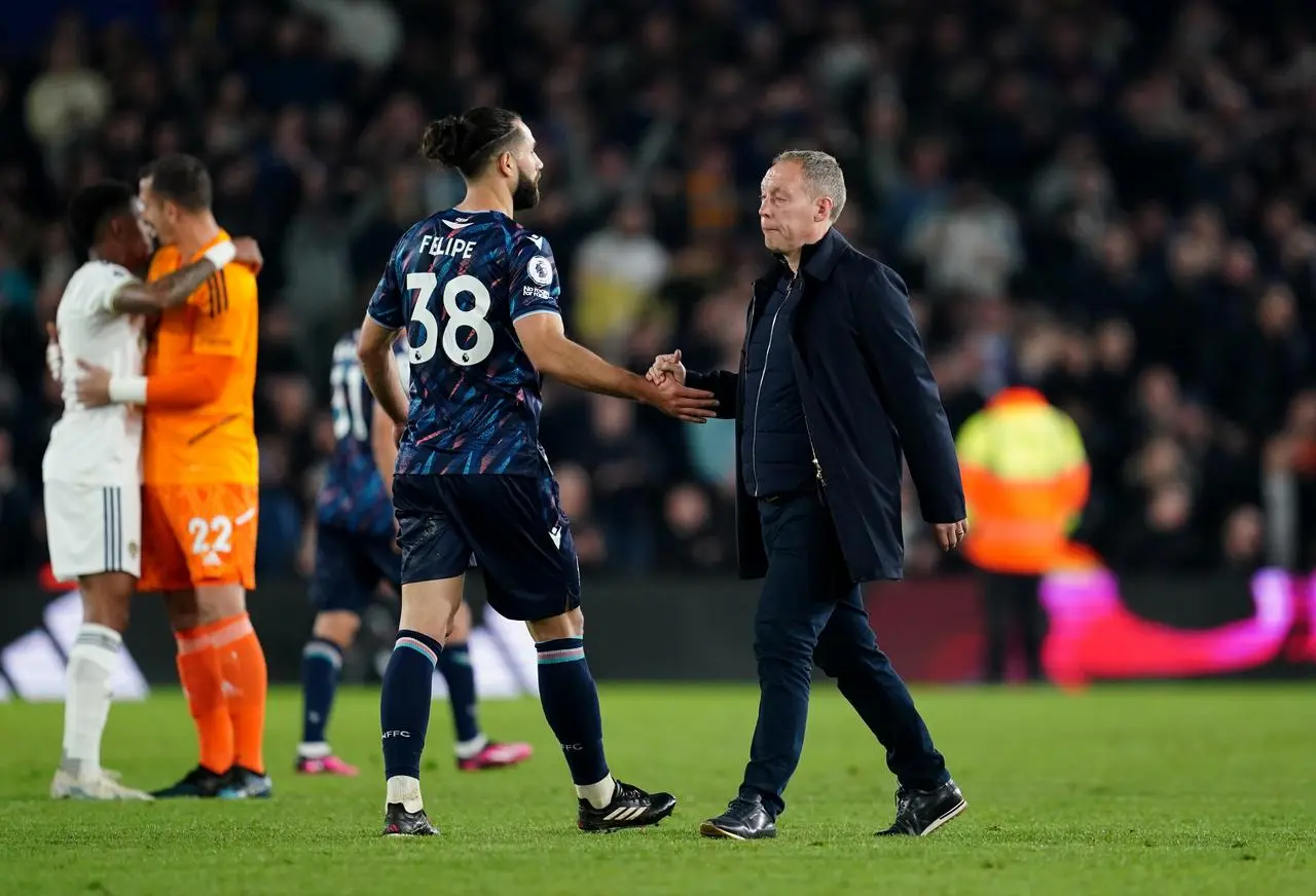 Steve Cooper, right, consoles defender Felipe after defeat to Leeds