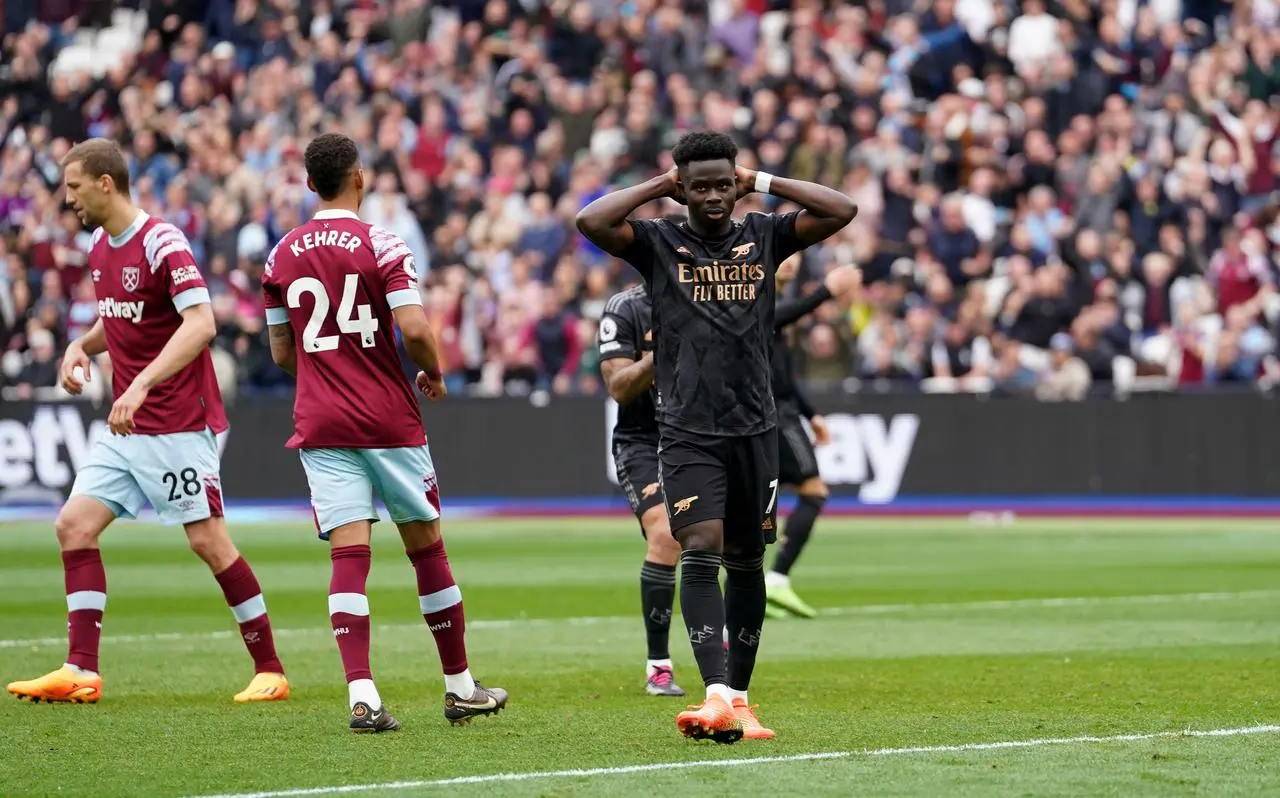 Bukayo Saka reacts after missing a penalty