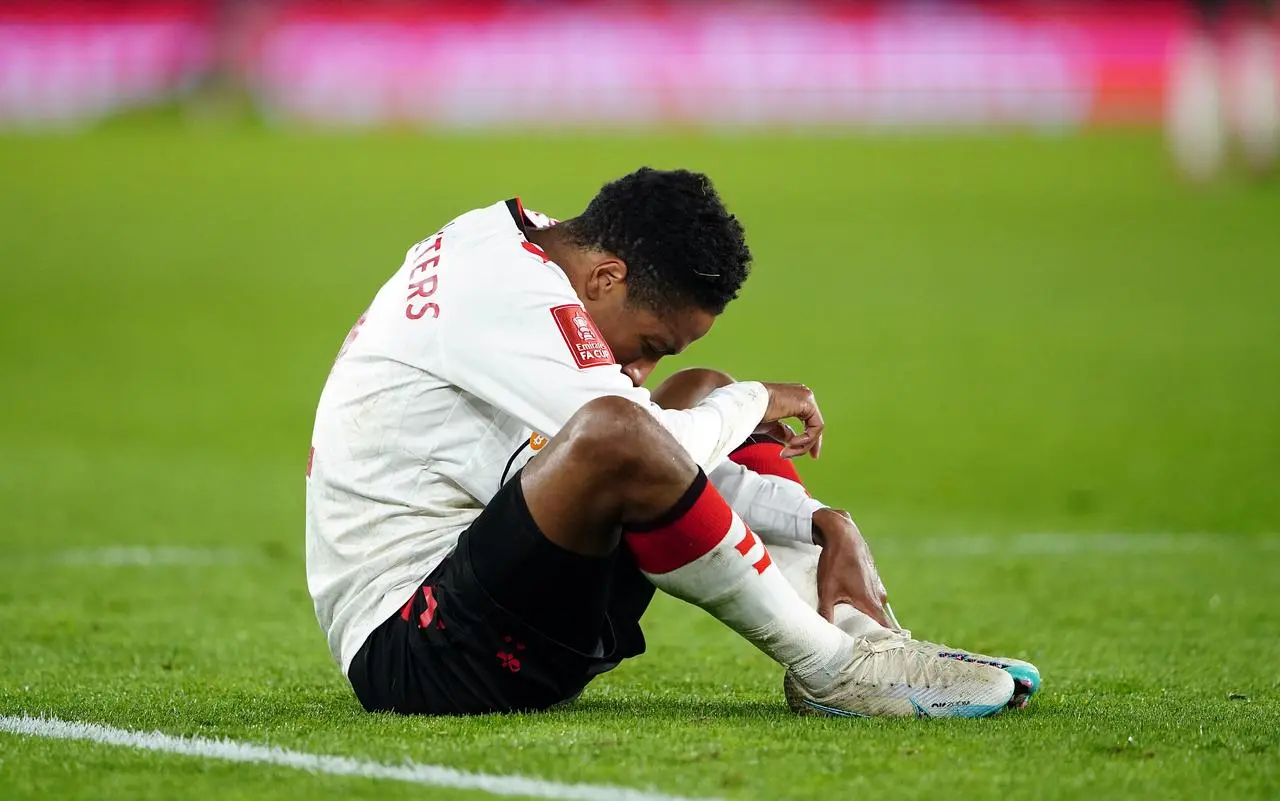 Kyle Walker-Peters looks dejected as he reacts to an ankle injury in the FA Cup loss to Grimsby