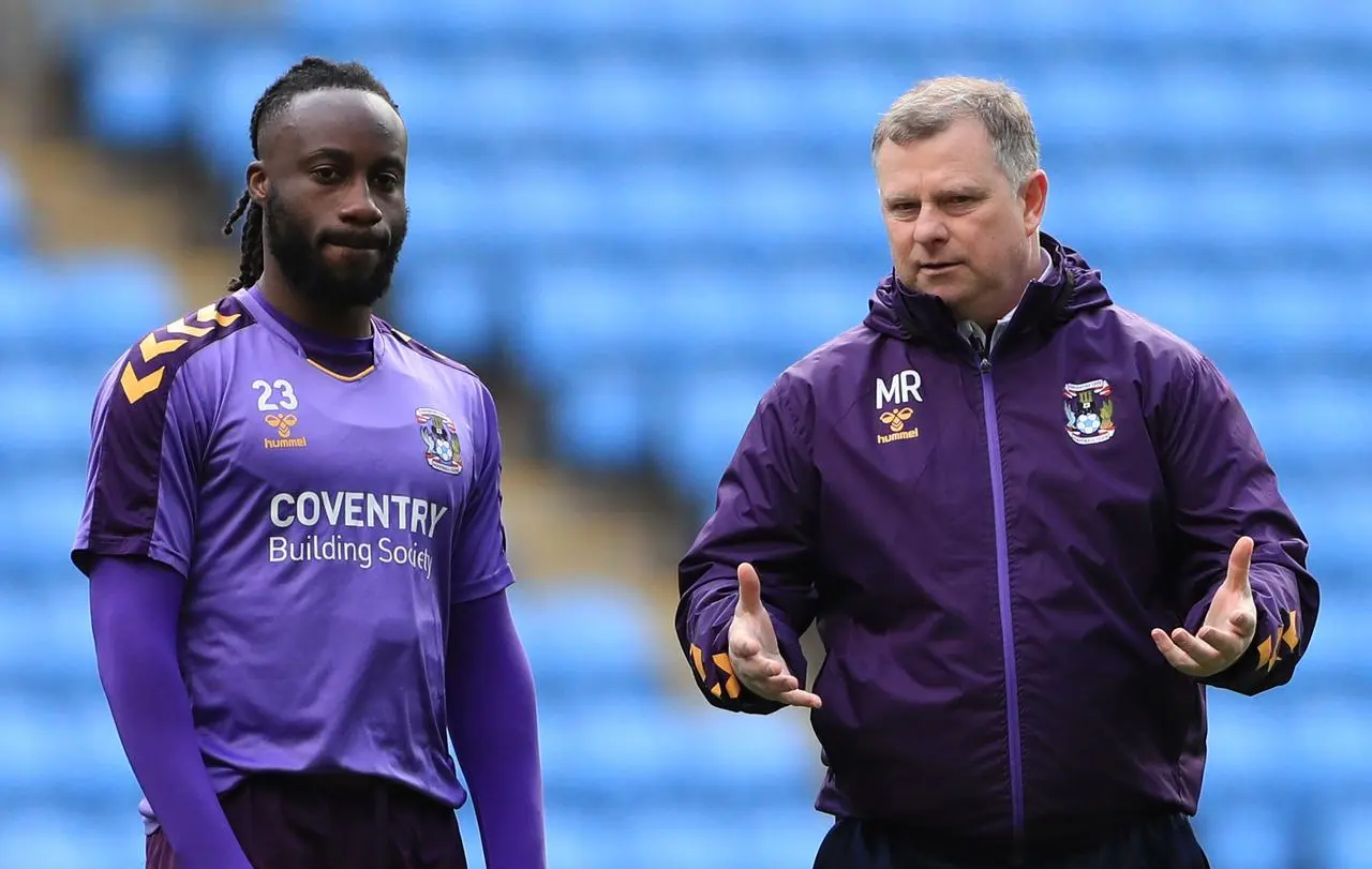 Coventry manager Mark Robins, right, speaks to Fankaty Dabo